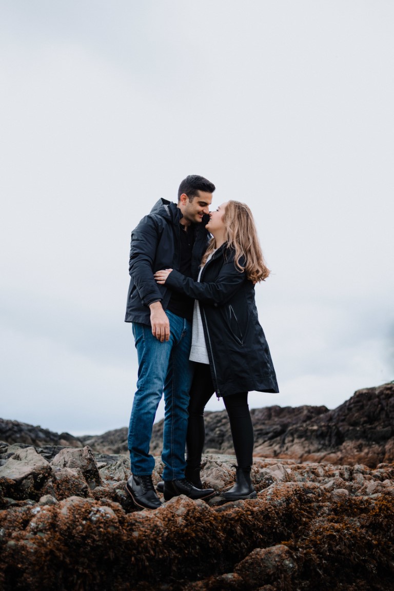 Couple walk along Tofino beach by Megan Maundrell