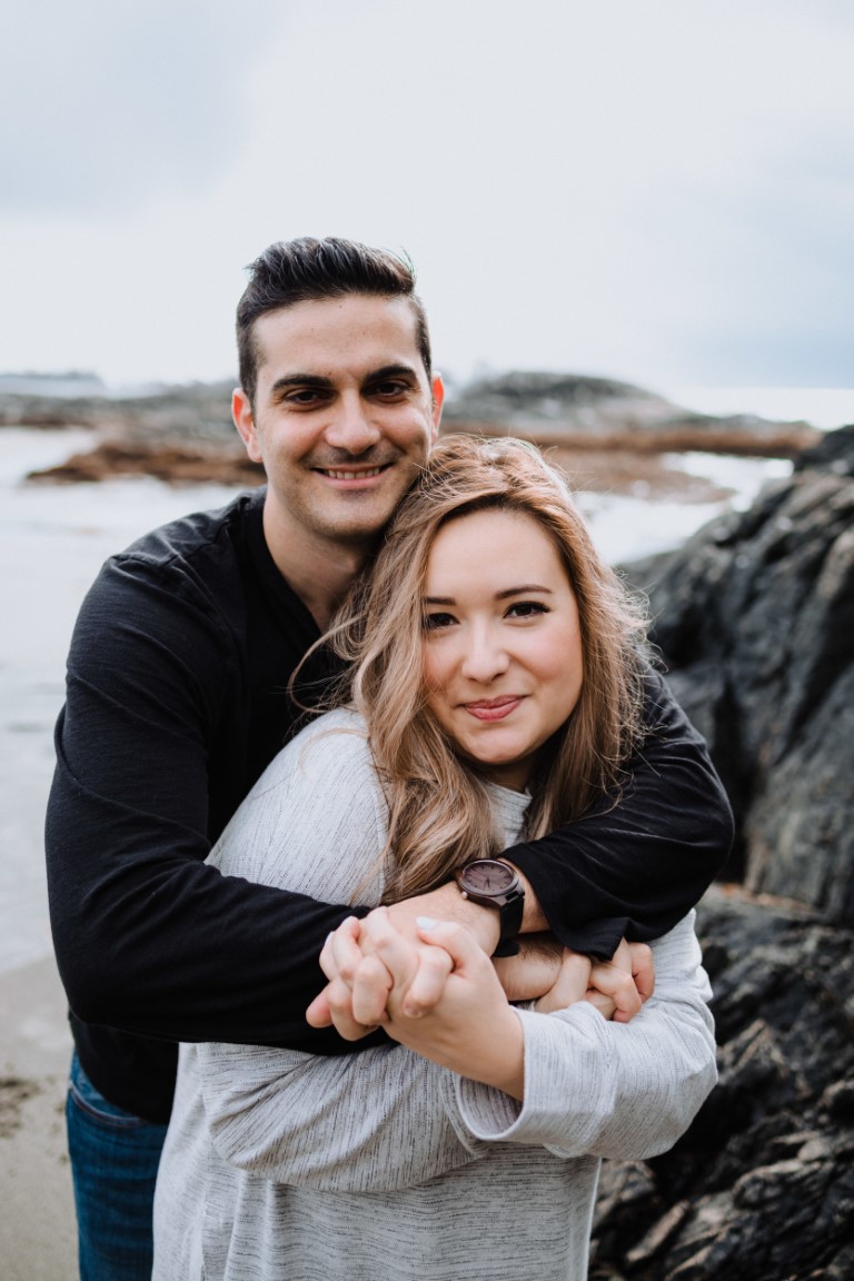 Engaged couple smile on Tofino beach