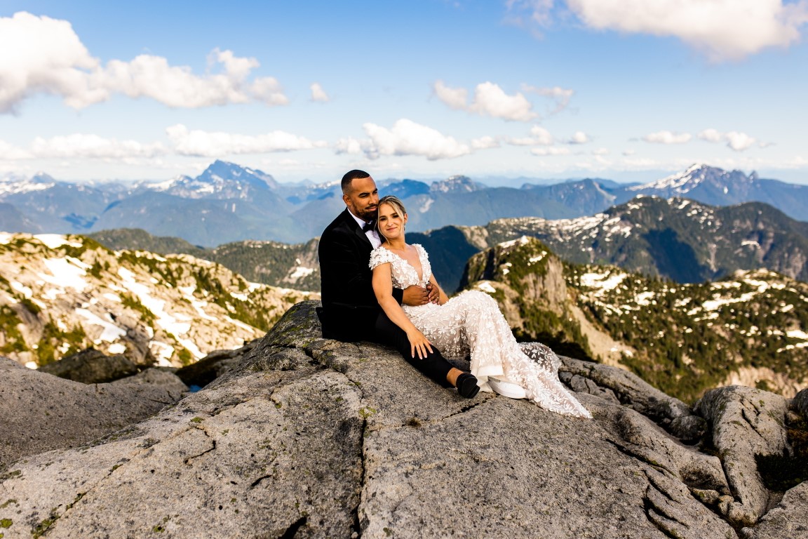 Vancouver bride and groom relax on mountaintop