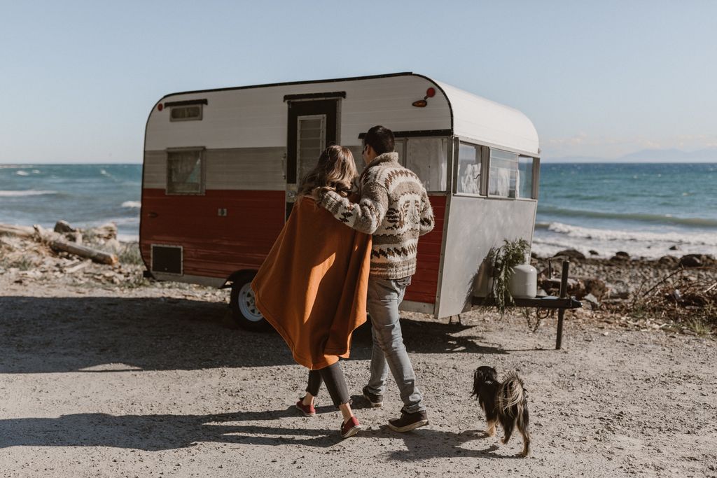 orange and white retro trailer with couple