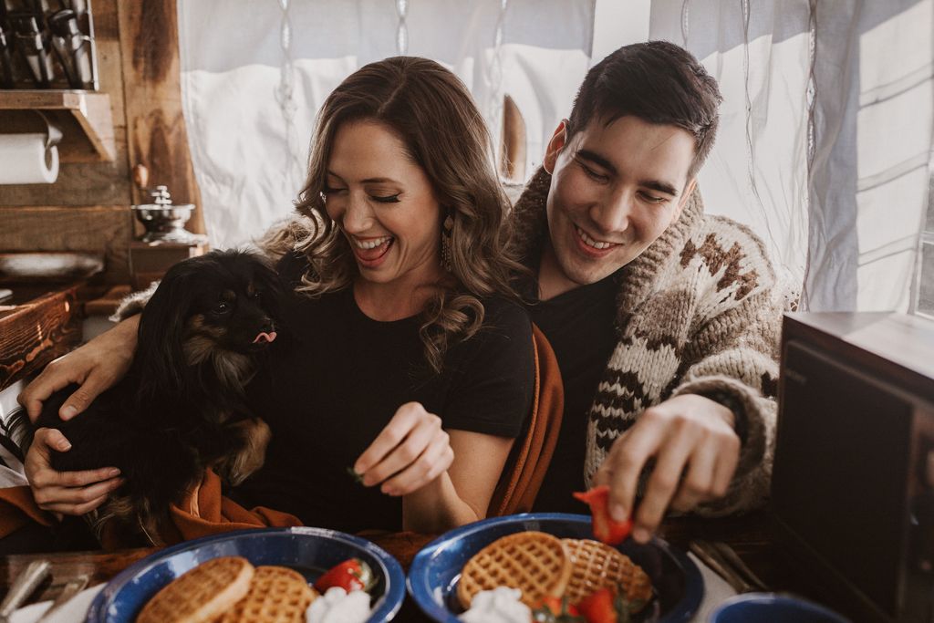 couple laugh during retro trailer engagement shoot