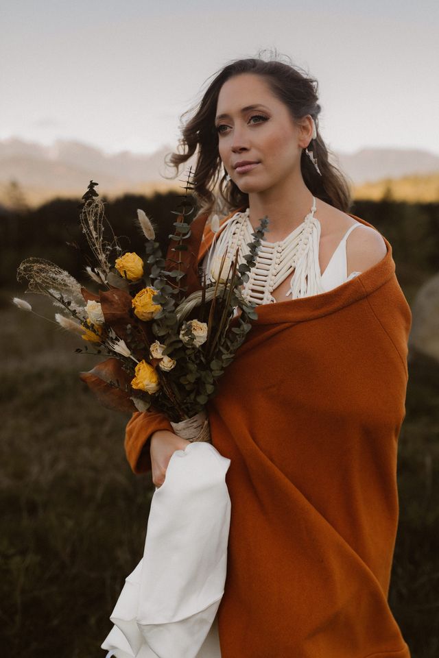 Indigenous bride wrapped in red blanket