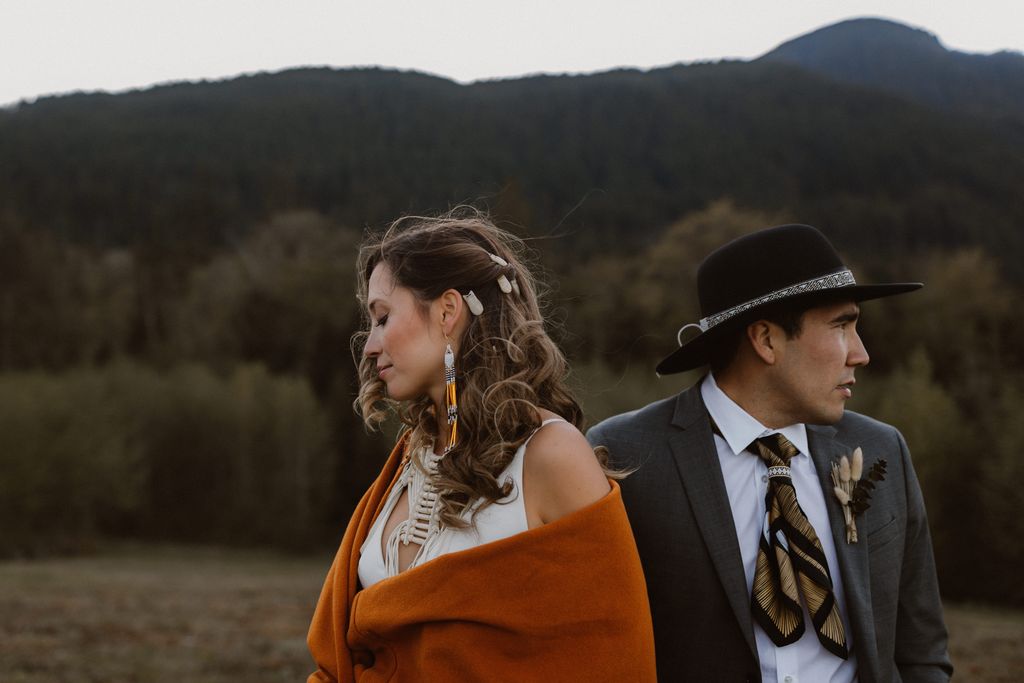 Indigenous couple with red blanket and hat