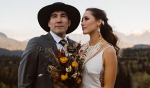 Indigenous couple look out at mountains