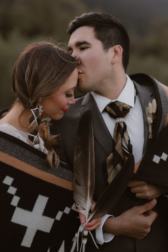 Eloping Indigenous couple in ceremony blanket