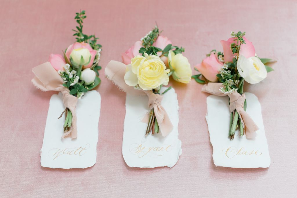 Wedding boutonnieres in blush and cream roses