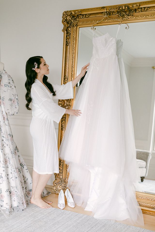 bride looks at her wedding gown