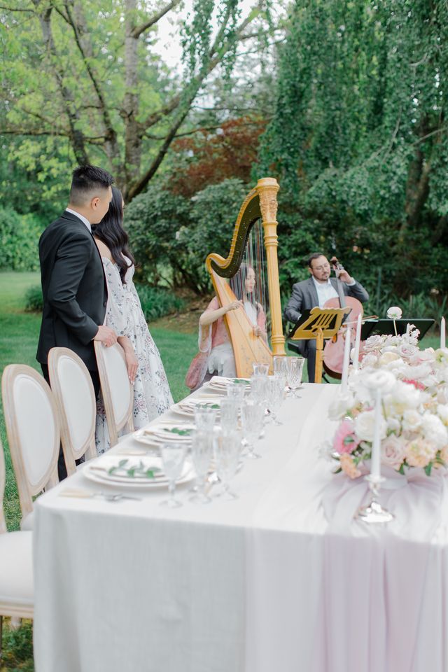 Newlyweds by outdoor reception table