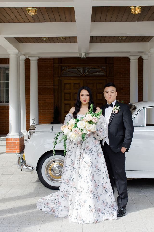 Newlyweds in front of vintage silver car