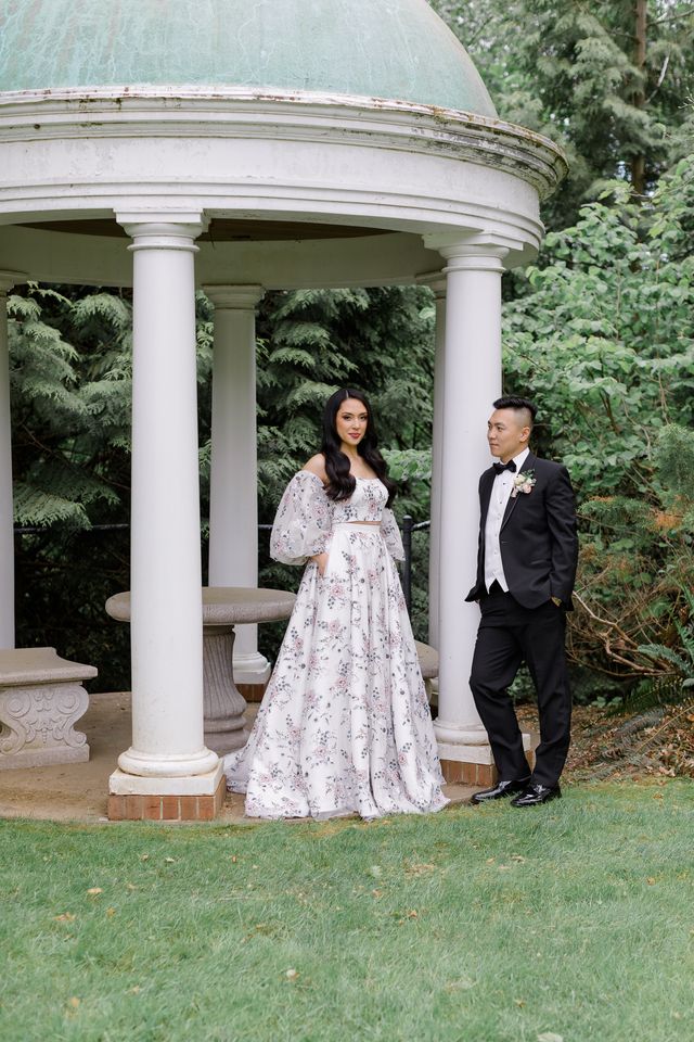 Newlyweds by gazebo with bride in floral gown