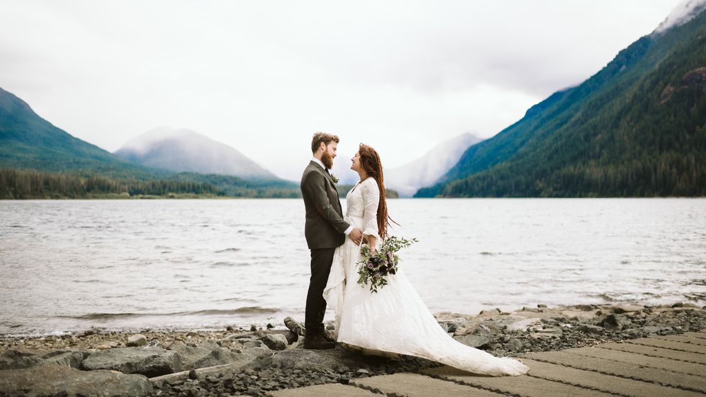 Wilderness + Waterfalls wedding Bride and groom on beach by Aly Sibley