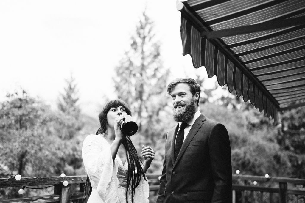 Bride drinks from wine bottle