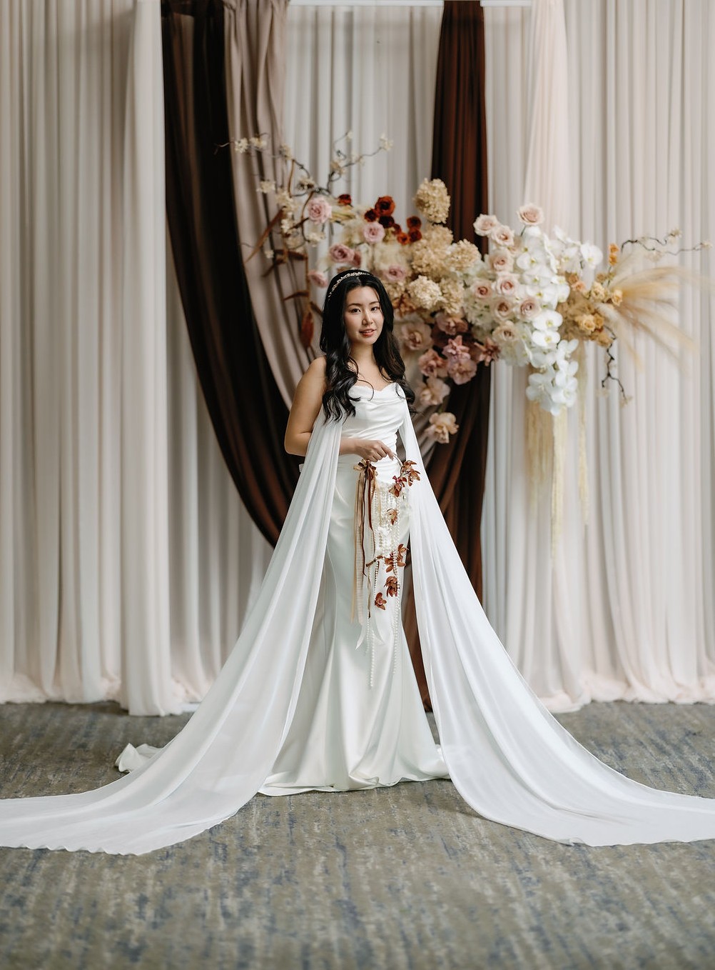 bride in vini vici bridal gown holding bouquet