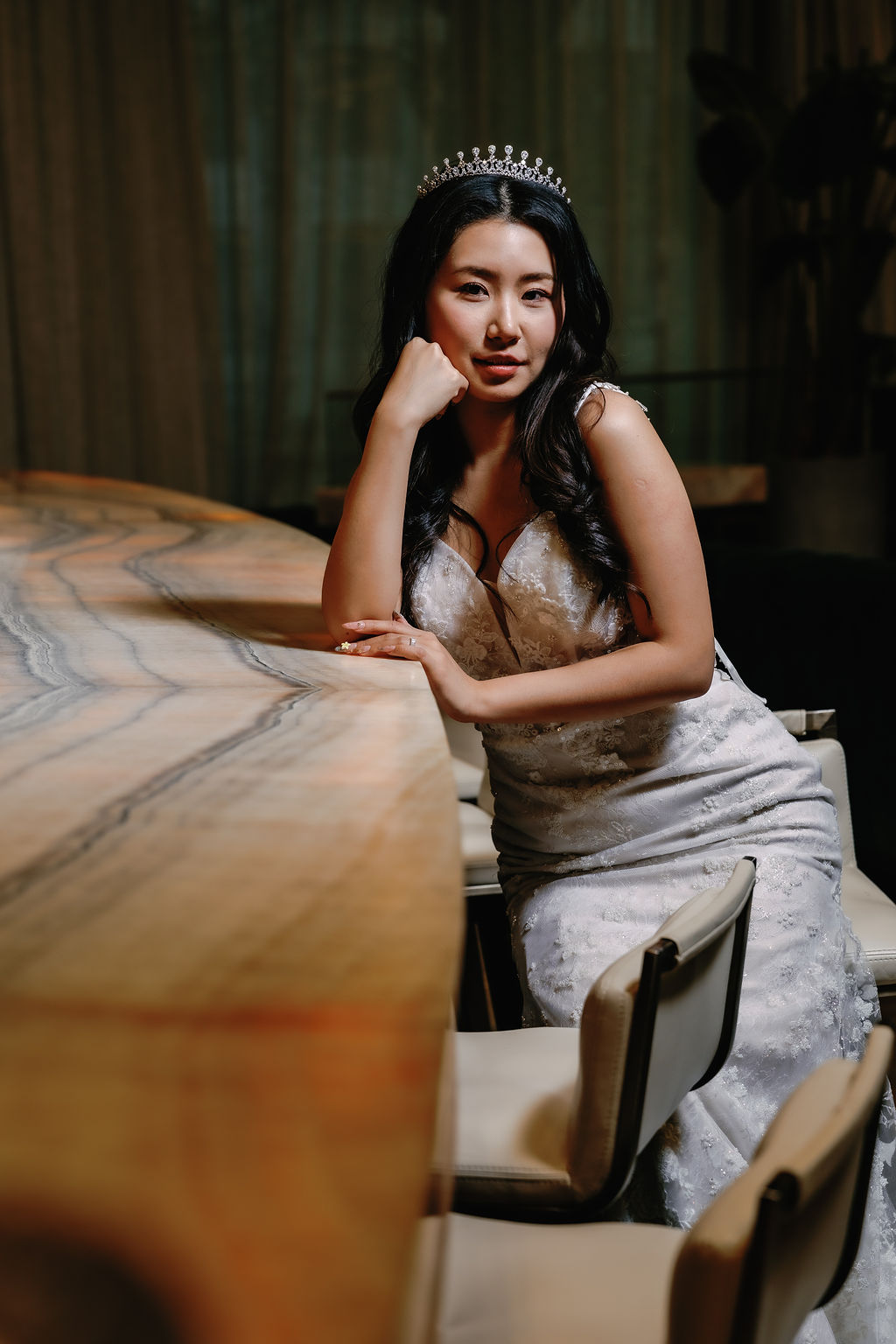 Bride sits along Paradox Vancouver Hotel bar by SoWedding