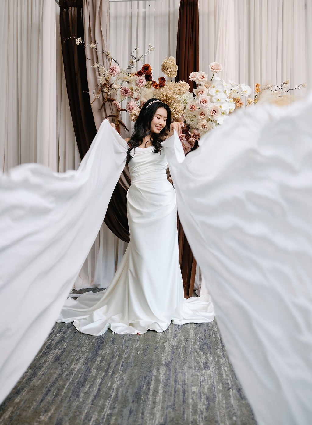 bride in gown with long panels by vini vici gowns