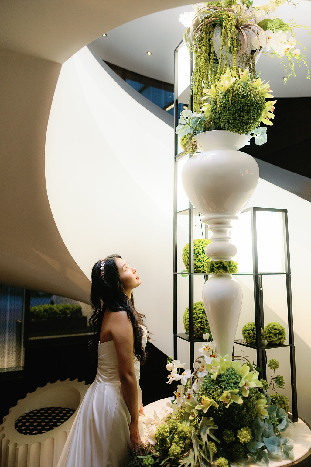 bride looks up at Paradox Vancouver lobby decor