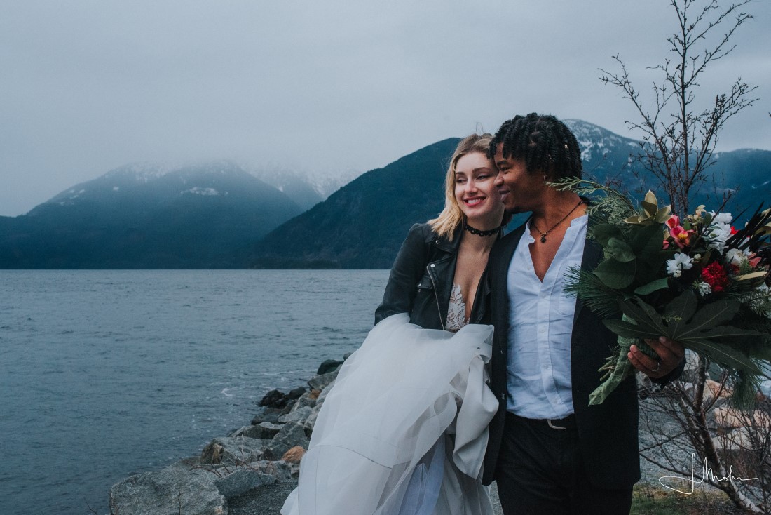 Couple kiss in canoe elopement