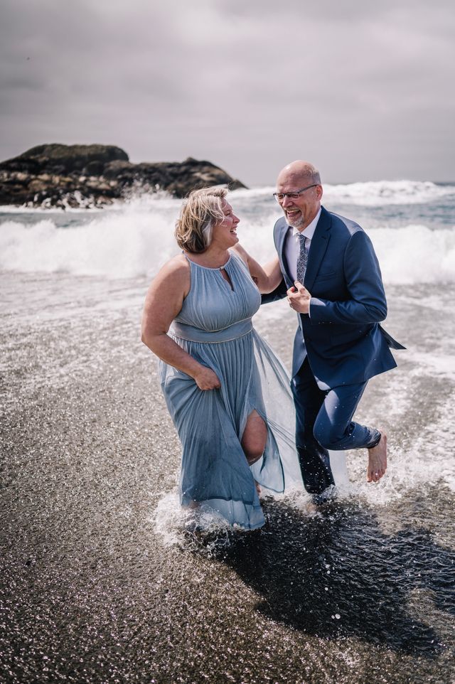 Eloping couple run in waves on Vancouver Island