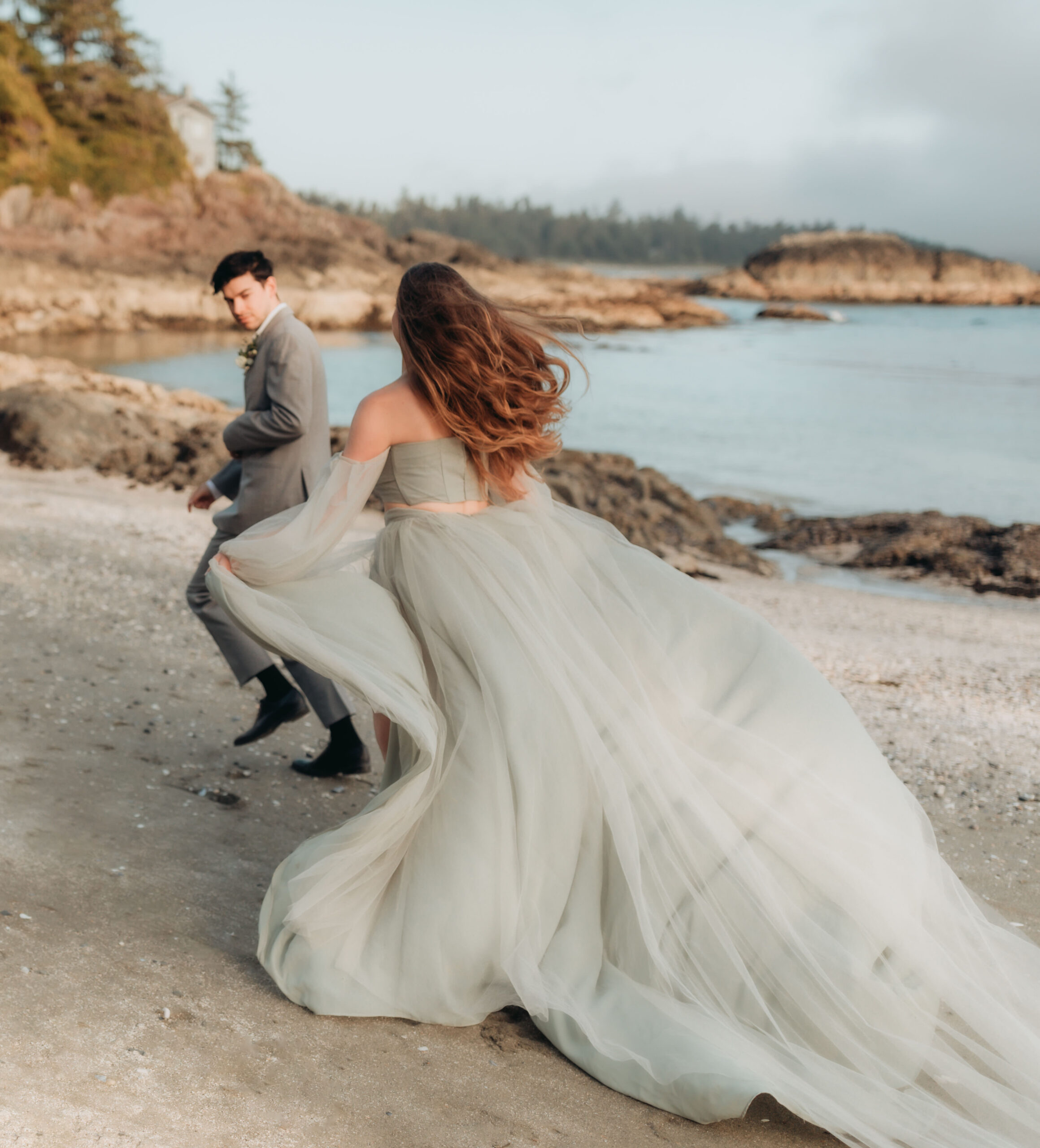 bride in green dress with groom on Tofino beach