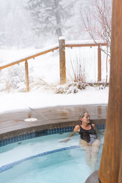 Woman relaxes in winter Tyax Lodge Spa pool