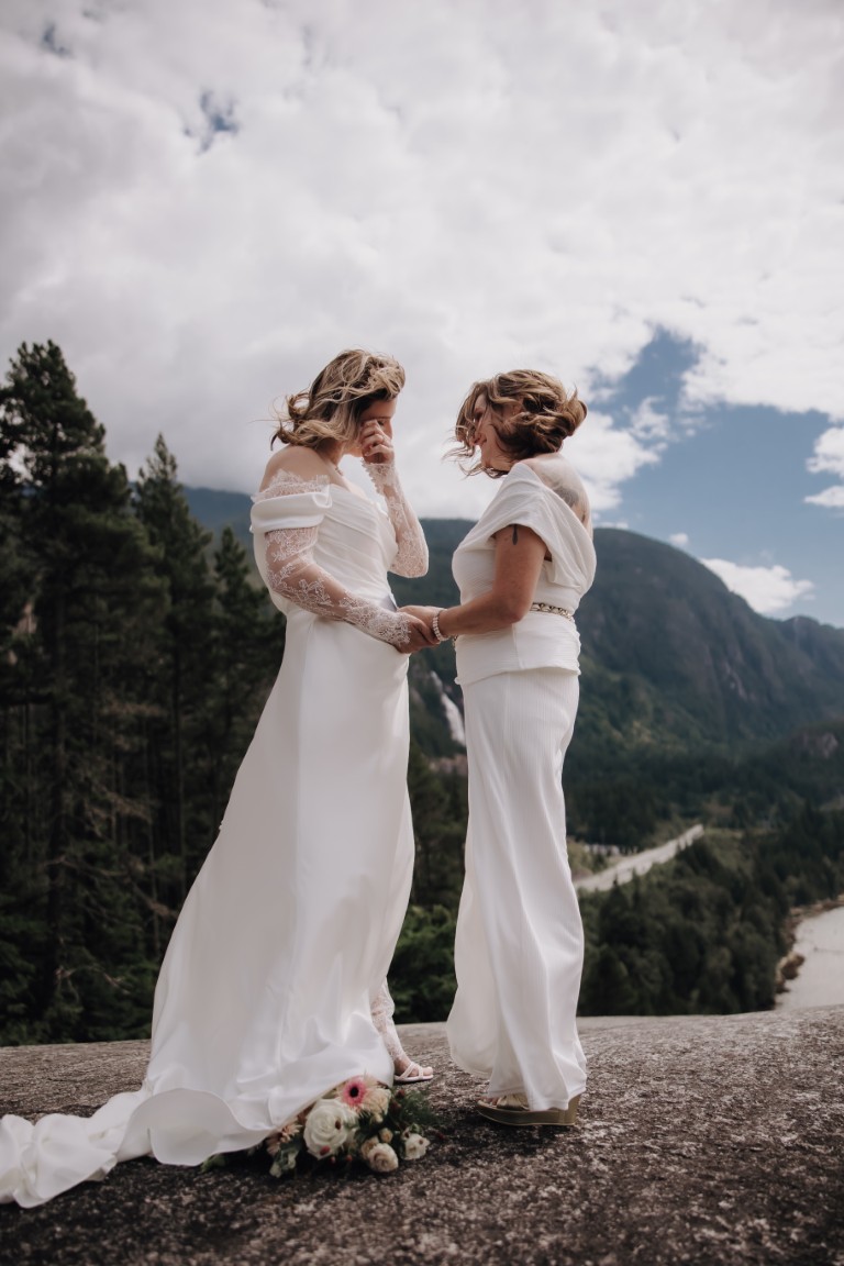 Two brides exchange vows on mountain by Unspoken Photography